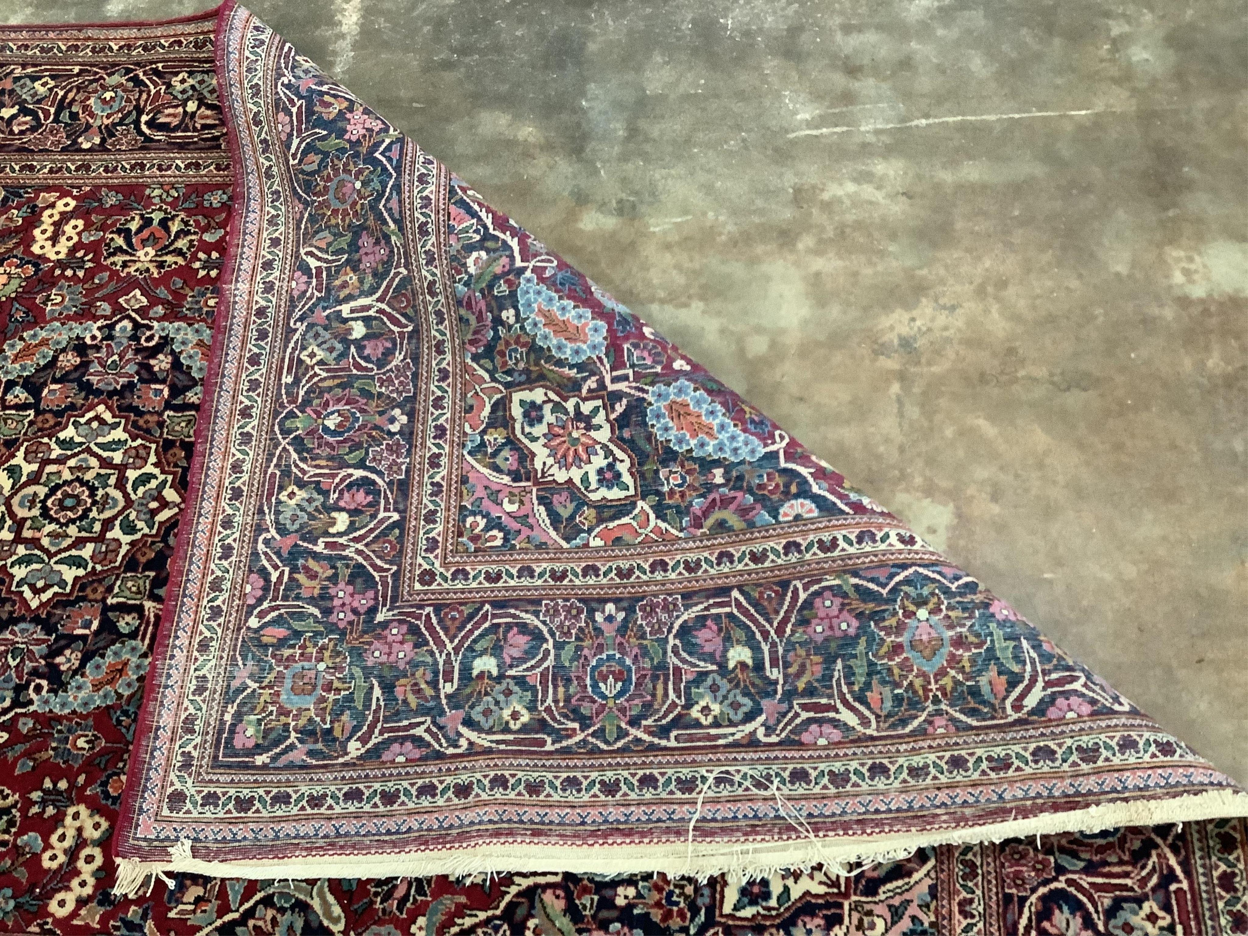 An Isphahan blue medallion rug, with a pink field, 210 x 128cm. Condition - fair